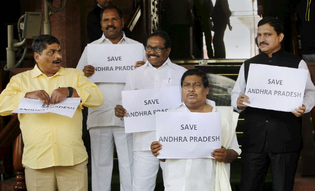 TDP members display placards for united Andhra Pradesh at Parliament House during the extended winter session in New Delhi on Thursday - PTI TDP members display placards for united Andhra Pradesh at Parliament House during the extended winter session in New Delhi on Thursday - PTI